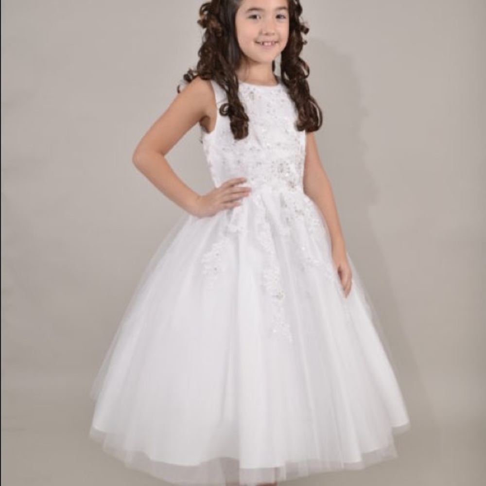 A white communion dress by Sweetie Pie Collection.